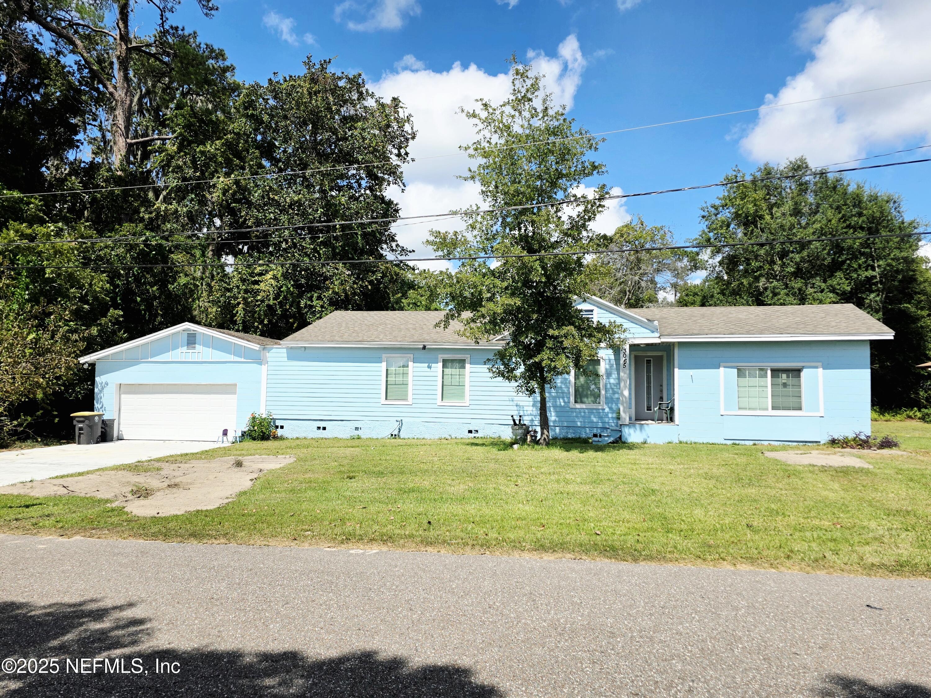 3065 Francis Road Jacksonville, FL 32209 - Photo 2 of 22 a front view of a house with a garden and trees