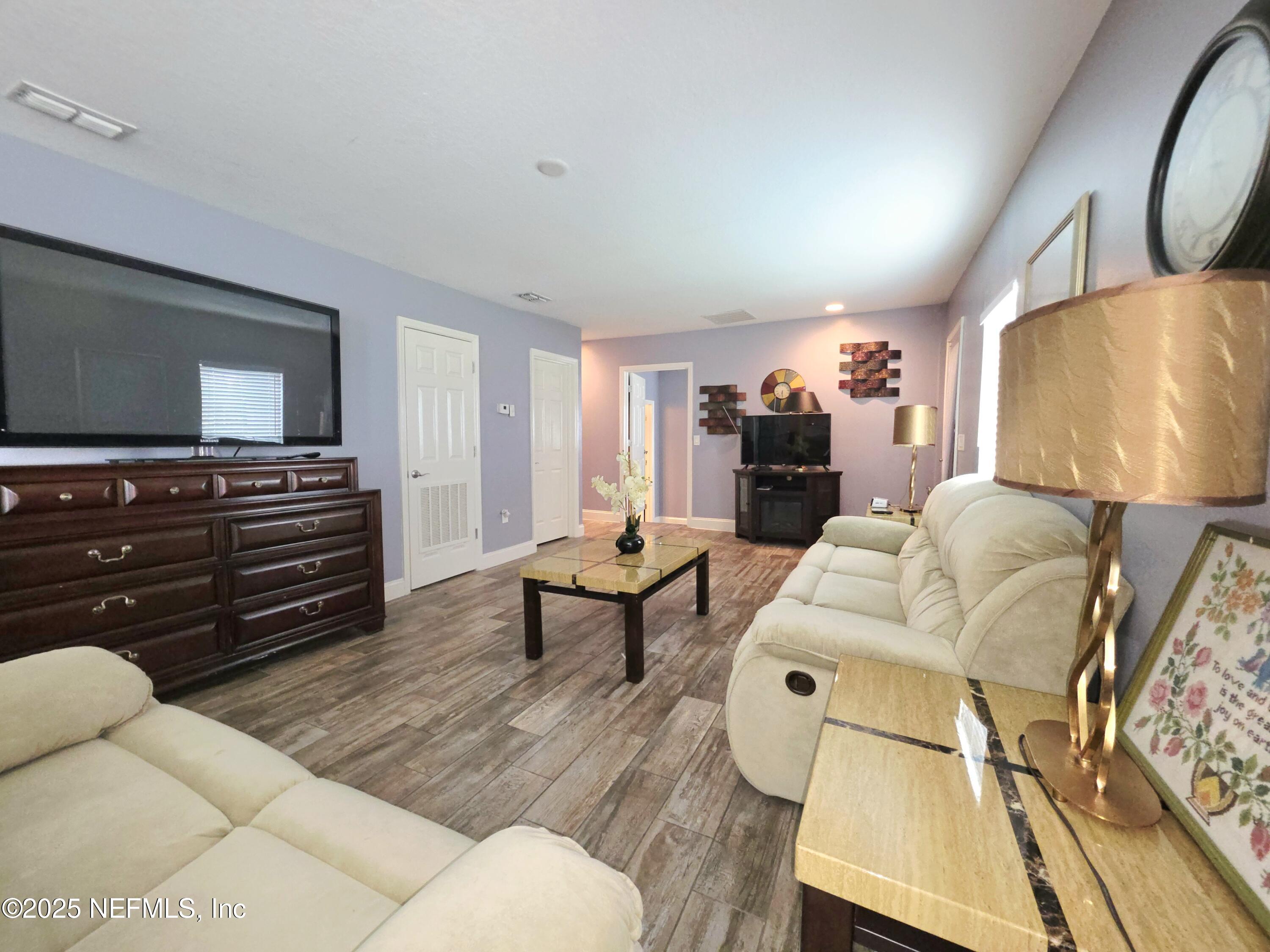 3065 Francis Road Jacksonville, FL 32209 - Photo 8 of 22 a living room with furniture and a flat screen tv