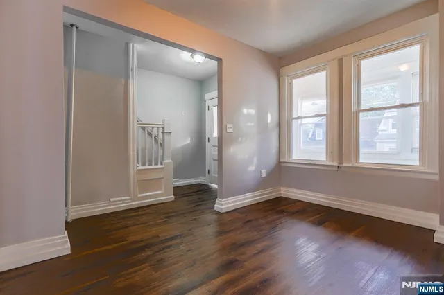 a view of wooden floor and windows in a room