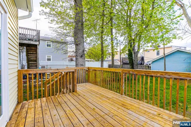 a view of balcony with wooden floor and fence