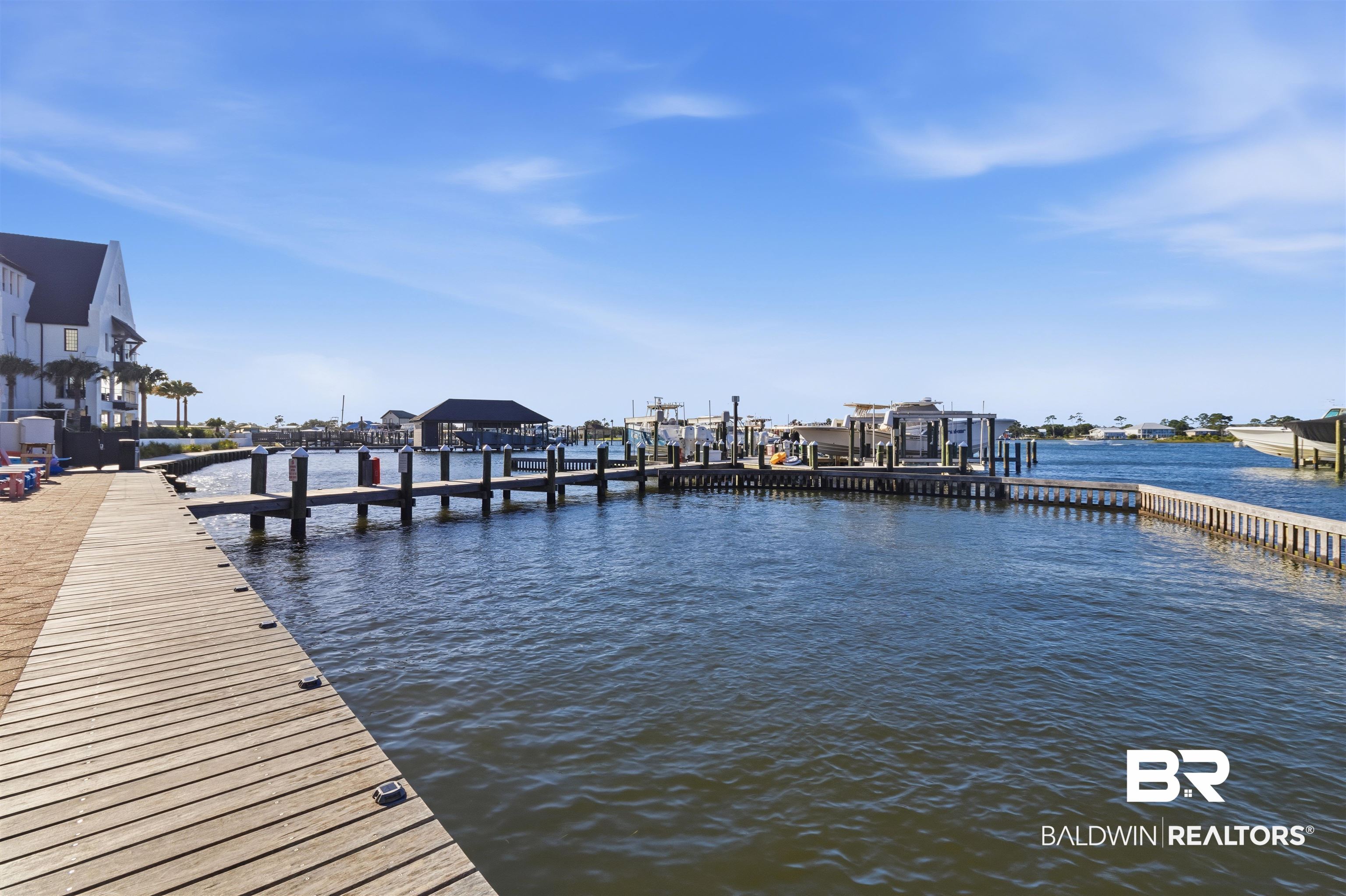 3564 Bayou Road, Unit 203 Orange Beach, AL 36561 - Photo 37 of 53 Waterfront property featuring a wood-plank boardwalk and multiple boat docks