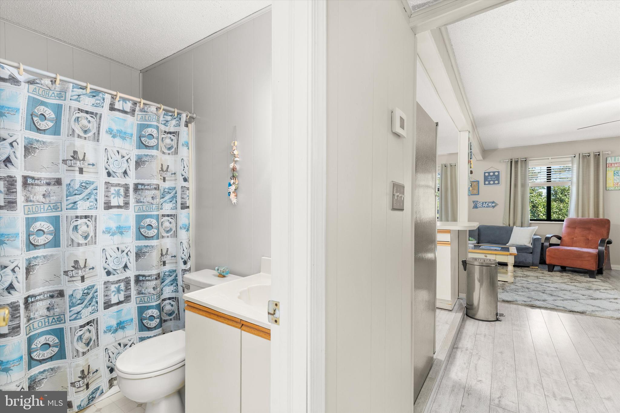 411 146th Street, Unit 332 Ocean City, MD 21842 - Photo 11 of 22 a bathroom with a toilet and a shower curtain