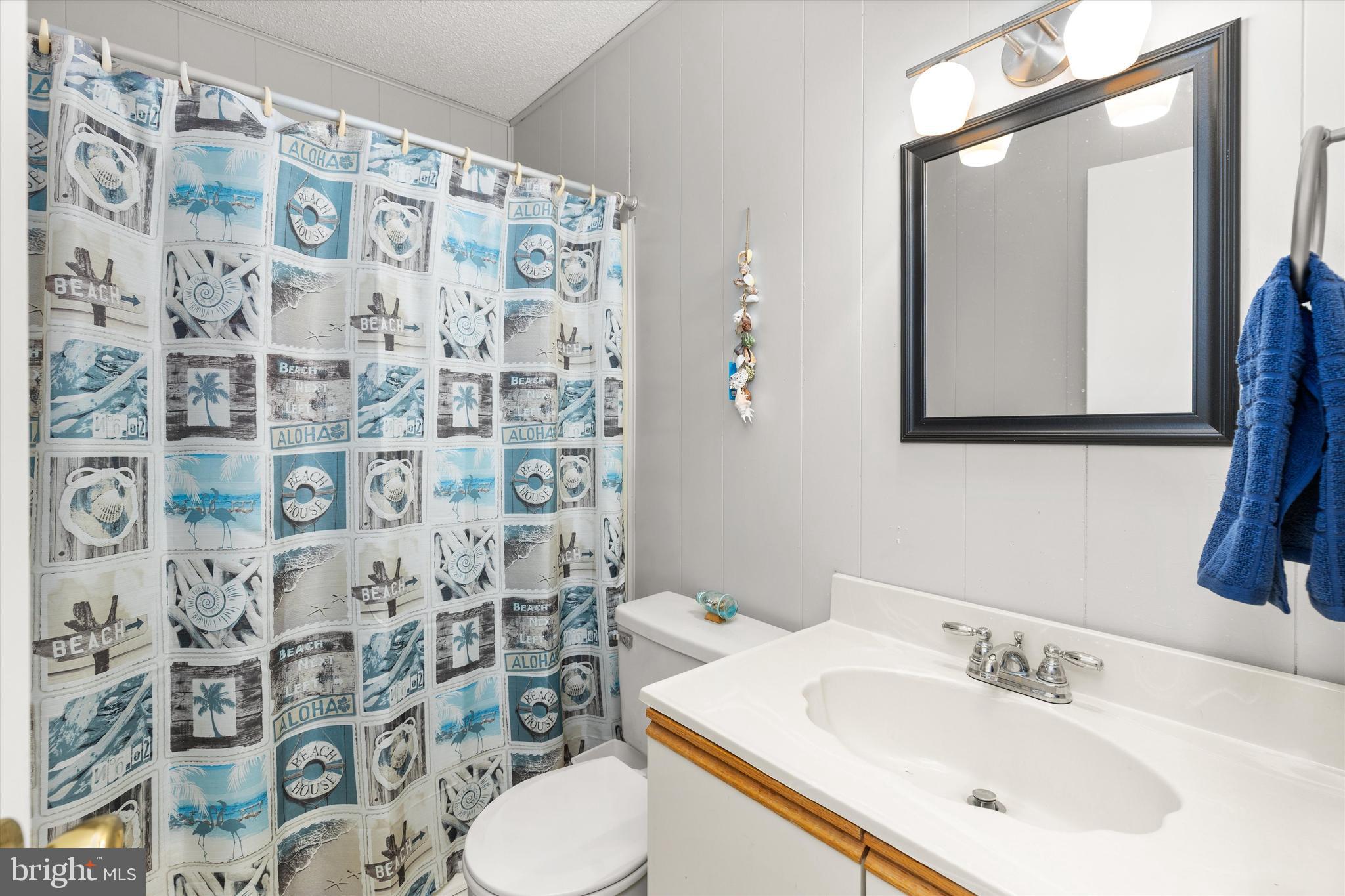 411 146th Street, Unit 332 Ocean City, MD 21842 - Photo 12 of 22 a bathroom with a sink and a mirror