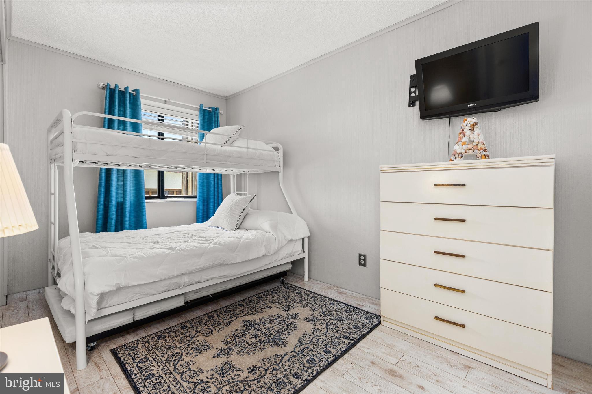 411 146th Street, Unit 332 Ocean City, MD 21842 - Photo 13 of 22 a bedroom with a bed and a flat screen tv