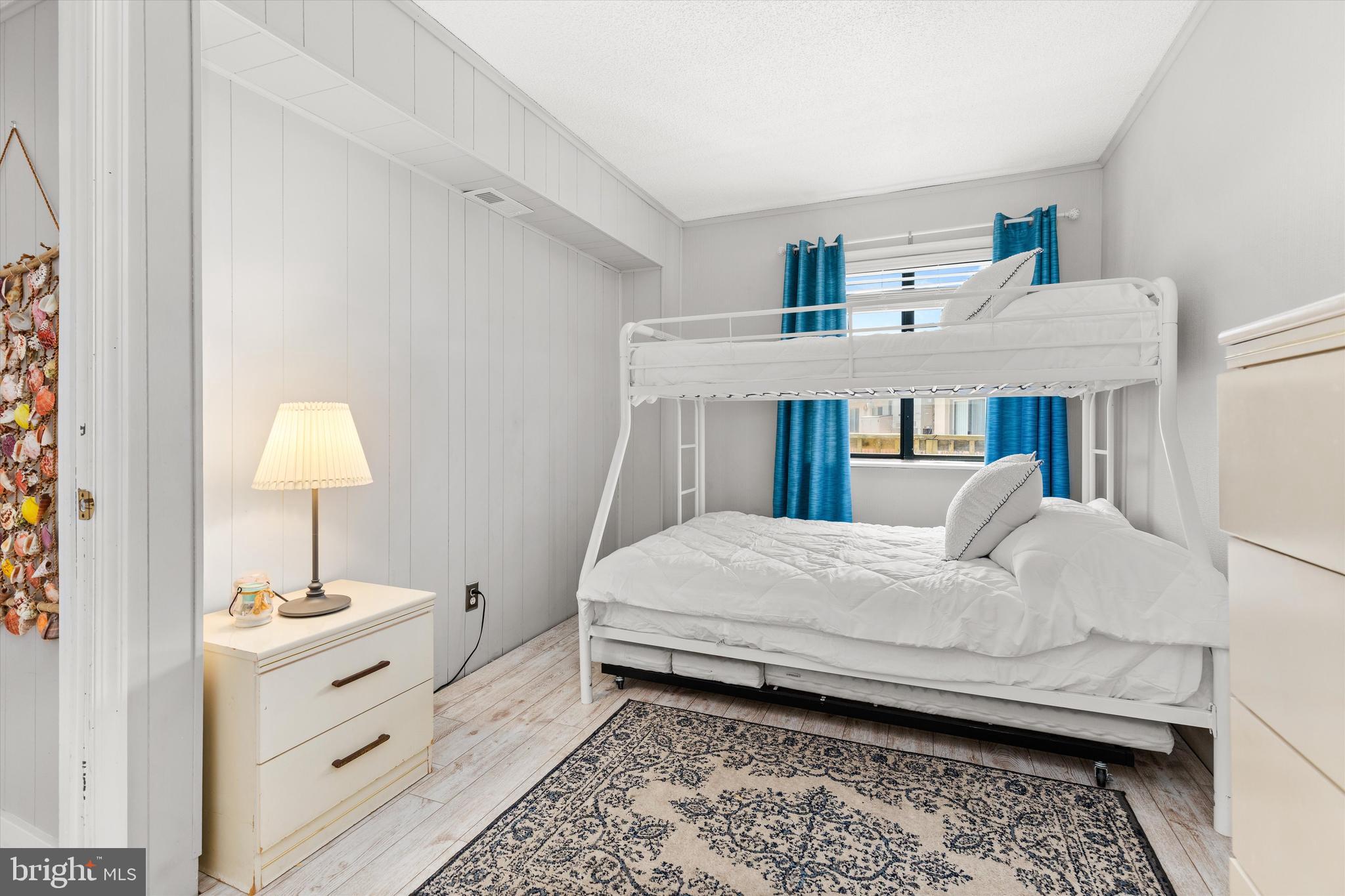 411 146th Street, Unit 332 Ocean City, MD 21842 - Photo 14 of 22 a bed room with a bed and a window