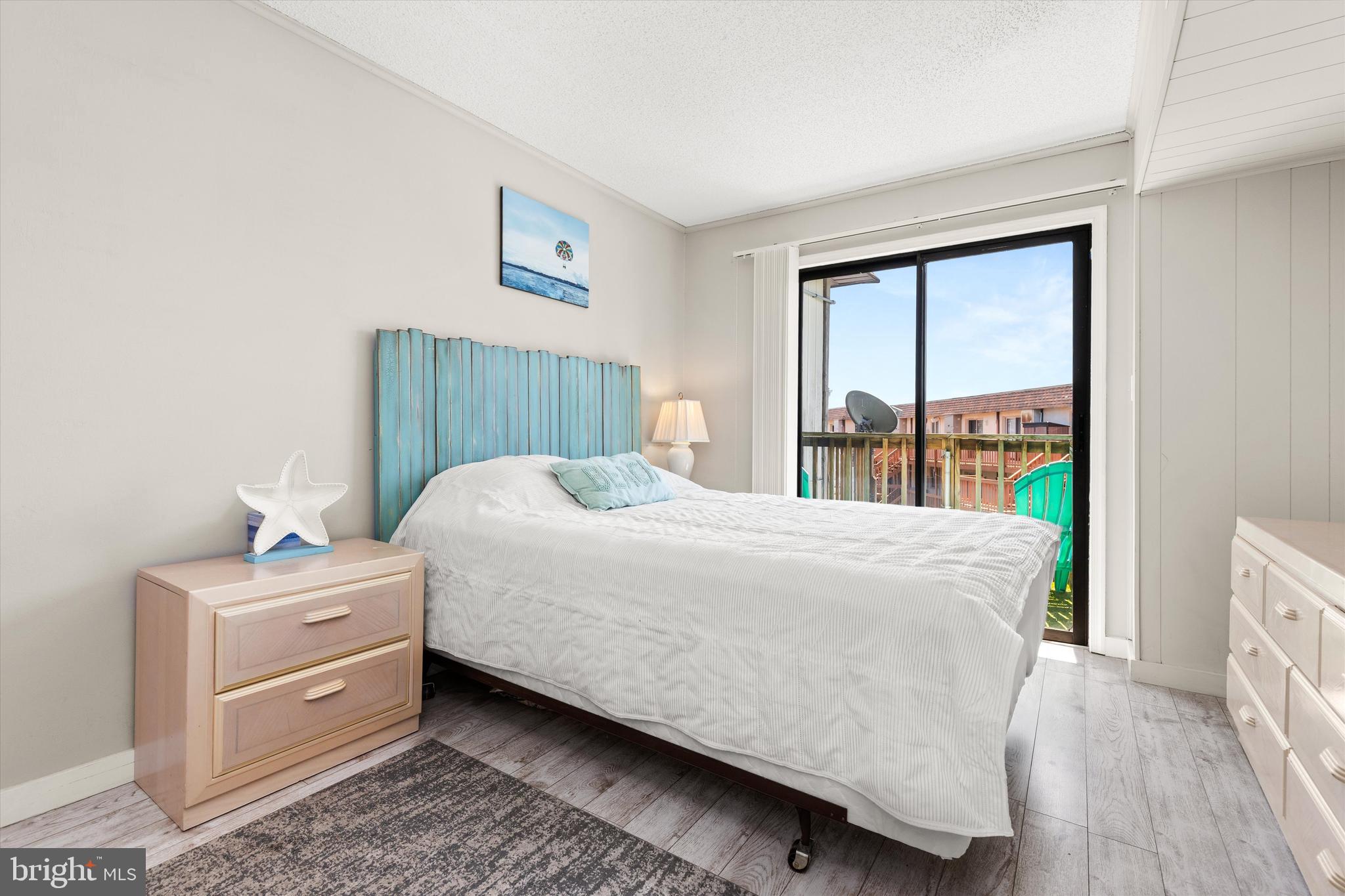 411 146th Street, Unit 332 Ocean City, MD 21842 - Photo 15 of 22 a bed sitting in a bedroom next to a window