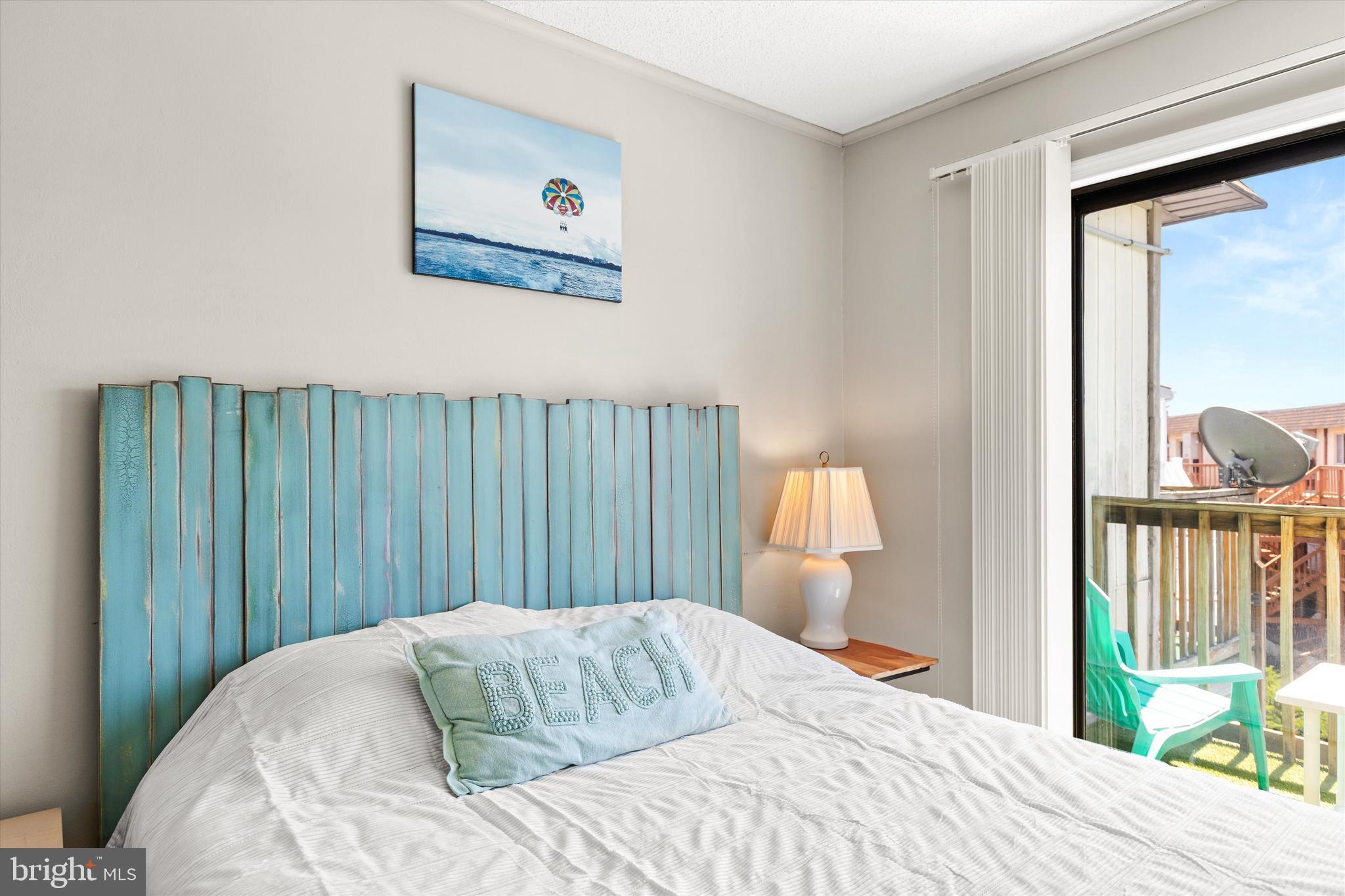 411 146th Street, Unit 332 Ocean City, MD 21842 - Photo 17 of 22 a bedroom with a bed and wooden floor