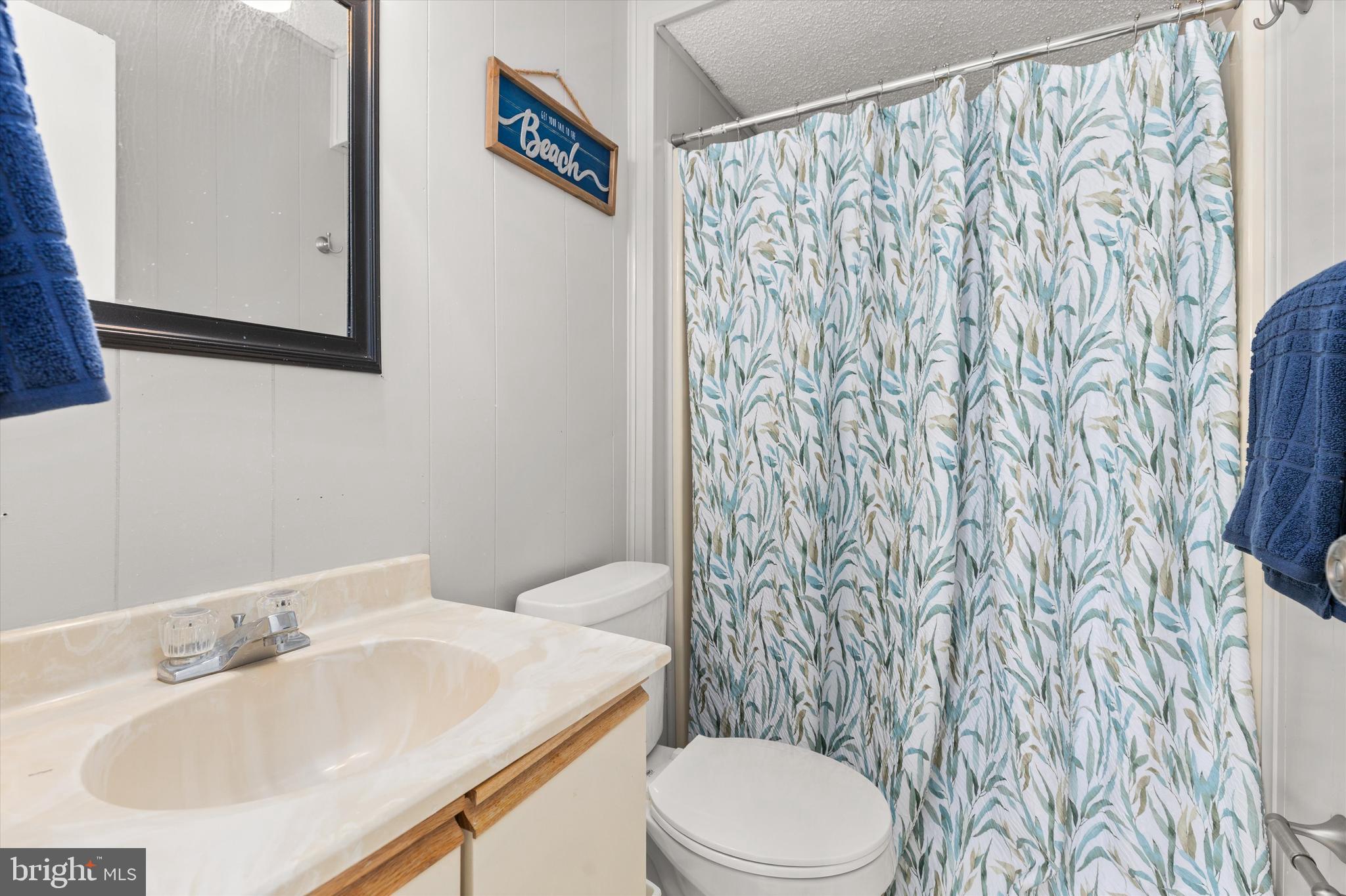 411 146th Street, Unit 332 Ocean City, MD 21842 - Photo 18 of 22 a bathroom with a sink and a mirror