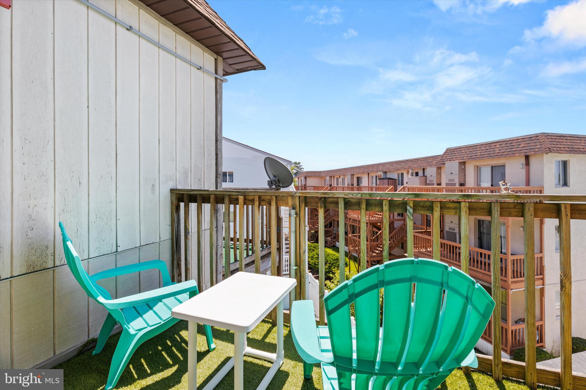 411 146th Street, Unit 332 Ocean City, MD 21842 - Photo 19 of 22 a view of a chair and table in the balcony