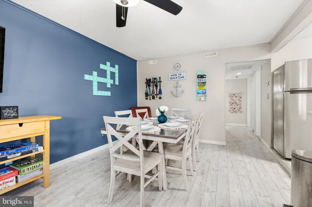 a view of a dining room with furniture and a kitchen
