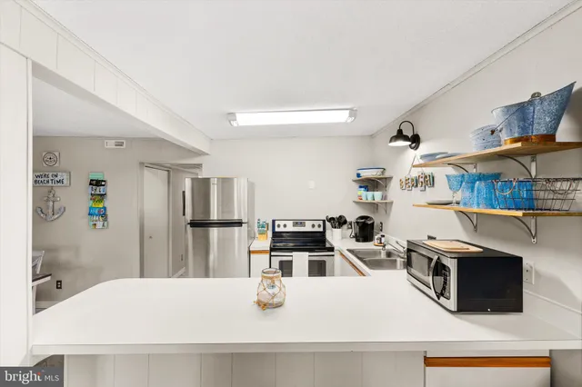 a kitchen with stainless steel appliances granite countertop a refrigerator and a stove