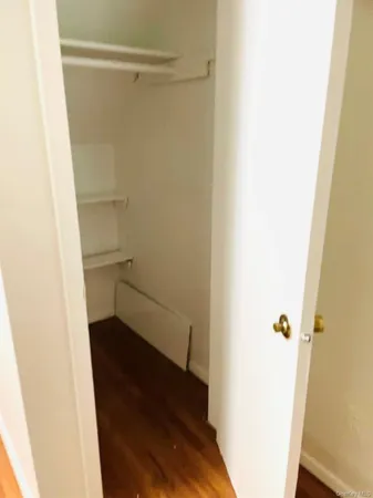 a view of walk in closet with empty racks