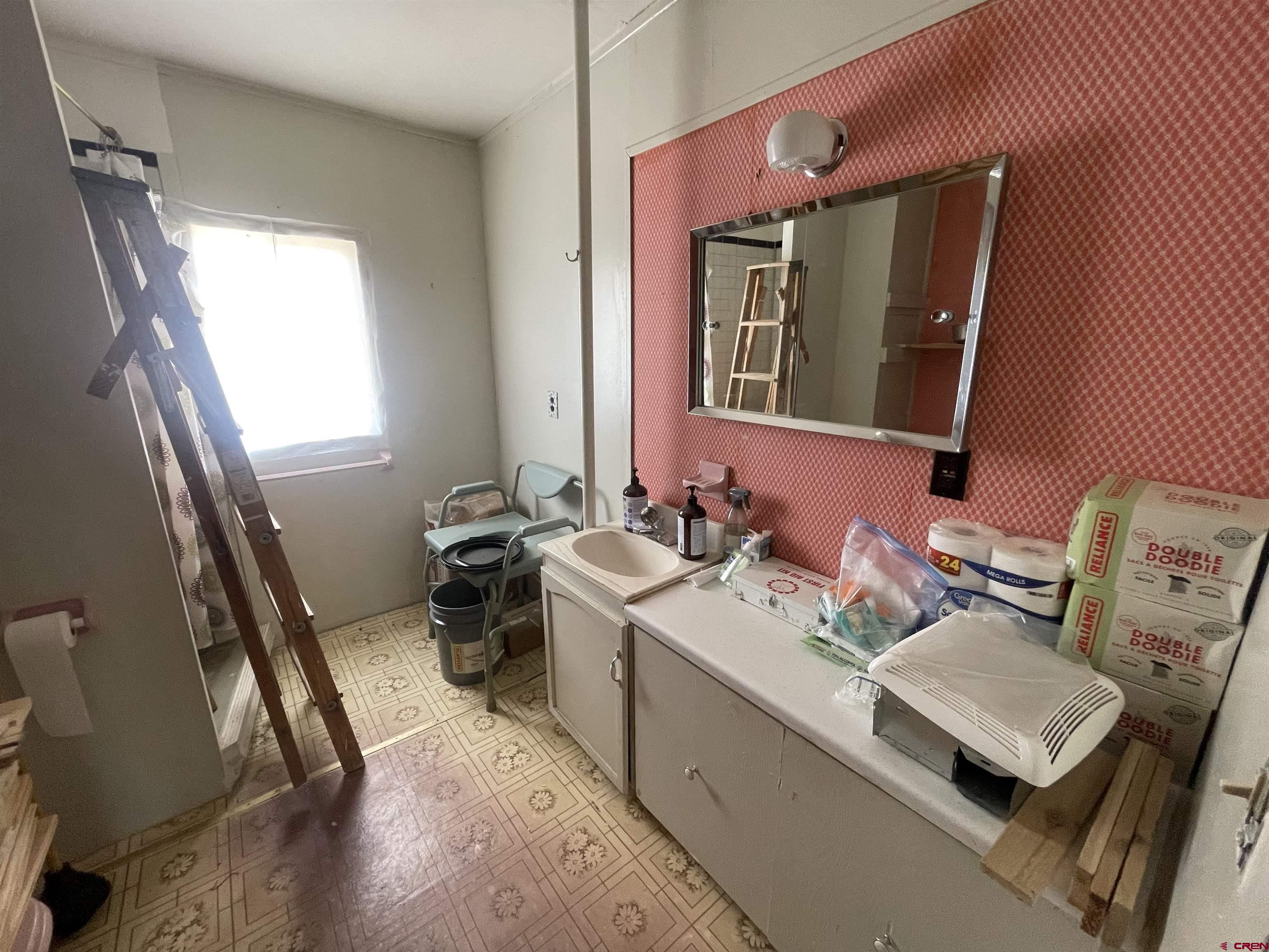 12753 Rd R Cahone, CO 81320 - Photo 9 of 24 a bathroom with a sink mirror and a toilet