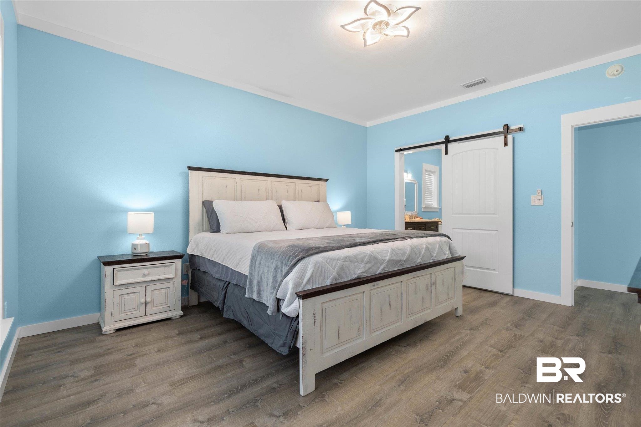 19878 Keller Road Foley, AL 36535 - Photo 14 of 35 Bedroom featuring a barn door and wood finished floors