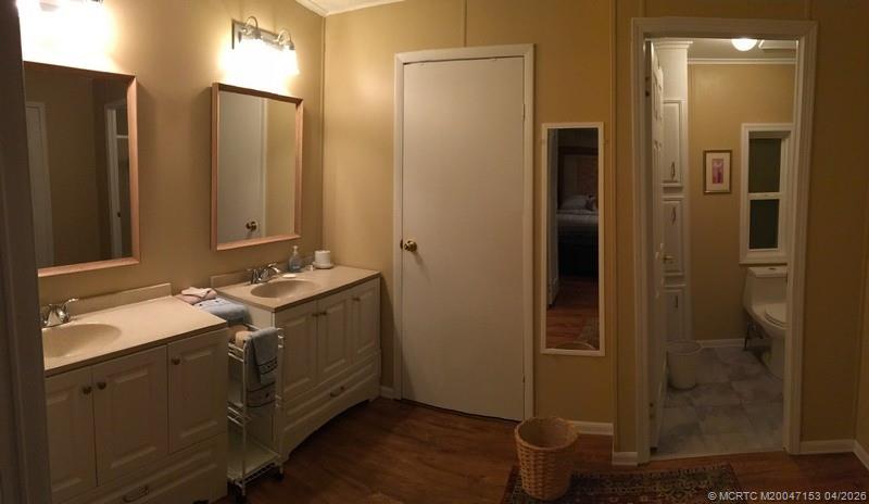 14514 Southwest Rake Drive Indiantown, FL 34956 - Photo 6 of 8 a bathroom with a granite countertop sink toilet and shower