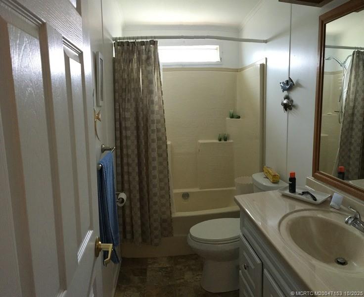 14514 Southwest Rake Drive Indiantown, FL 34956 - Photo 6 of 10 a bathroom with a sink toilet and shower