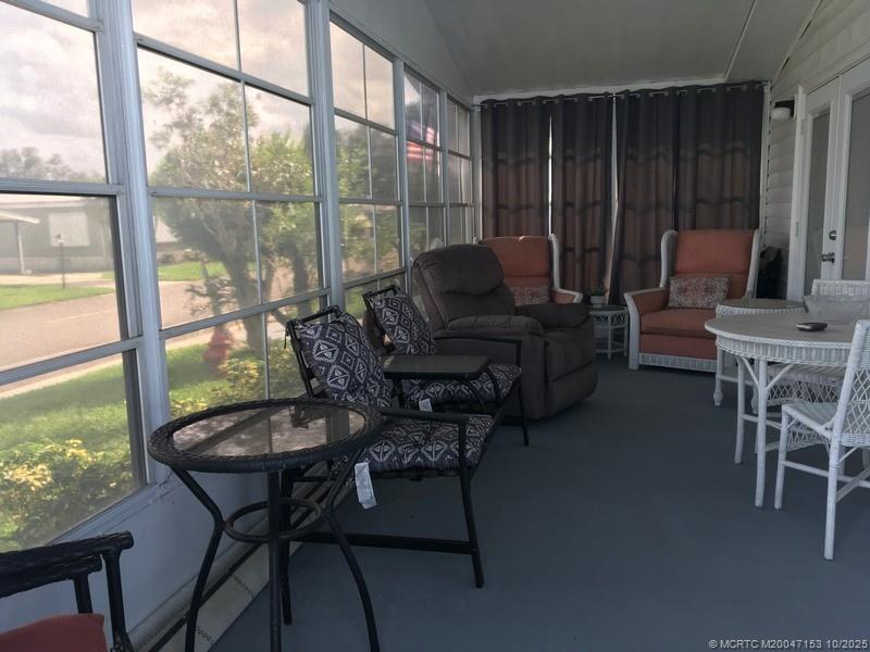 14514 Southwest Rake Drive Indiantown, FL 34956 - Photo 10 of 10 a living room with furniture and a floor to ceiling window