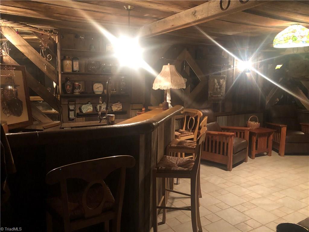 369 Cook Road Pilot Mountain, NC 27041 - Photo 21 of 30 Large Man cave in basement has wet bar, large fireplace, closet, seating area and is heated and cooled. Great space for entertaining.