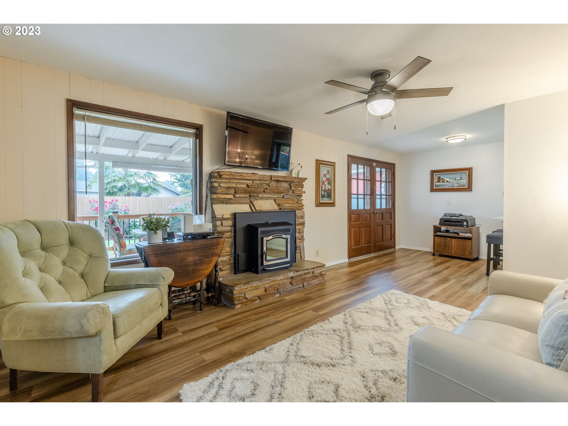 316 70th Street Springfield, OR 97478 - Photo 12 of 25 a living room with furniture a fireplace and a flat screen tv