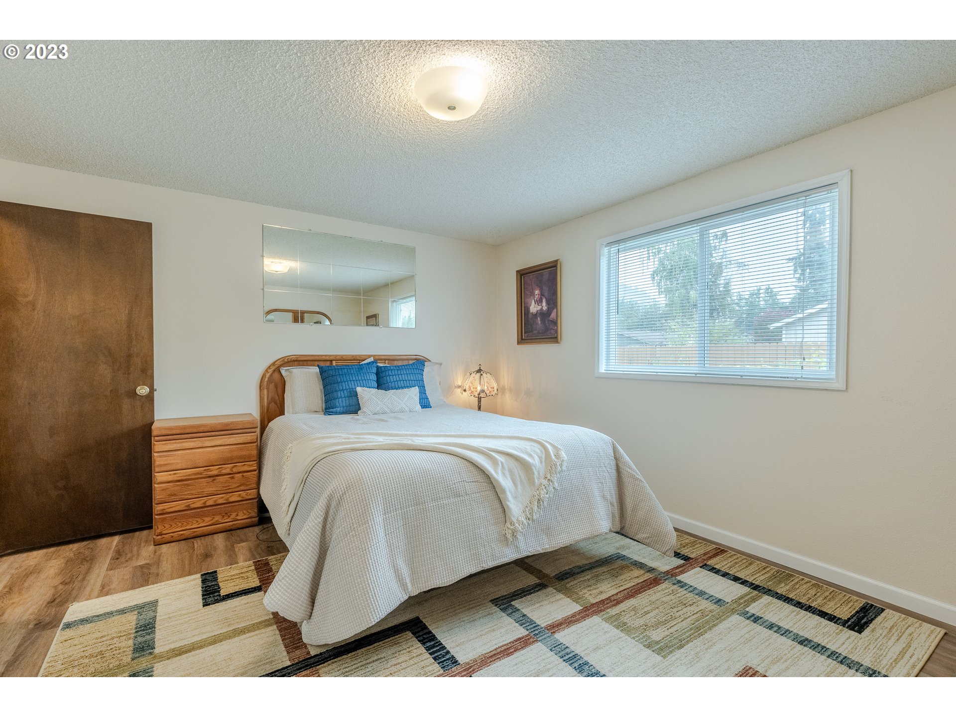316 70th Street Springfield, OR 97478 - Photo 15 of 25 a bedroom with a bed and a painting on the wall
