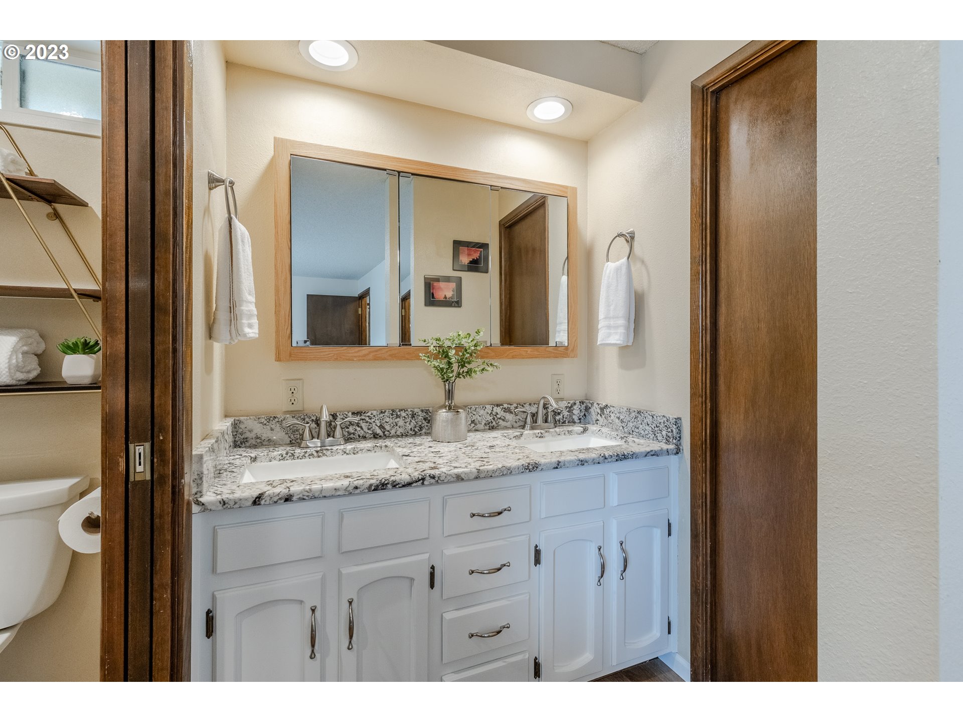316 70th Street Springfield, OR 97478 - Photo 16 of 25 a bathroom with a granite countertop sink vanity and a mirror