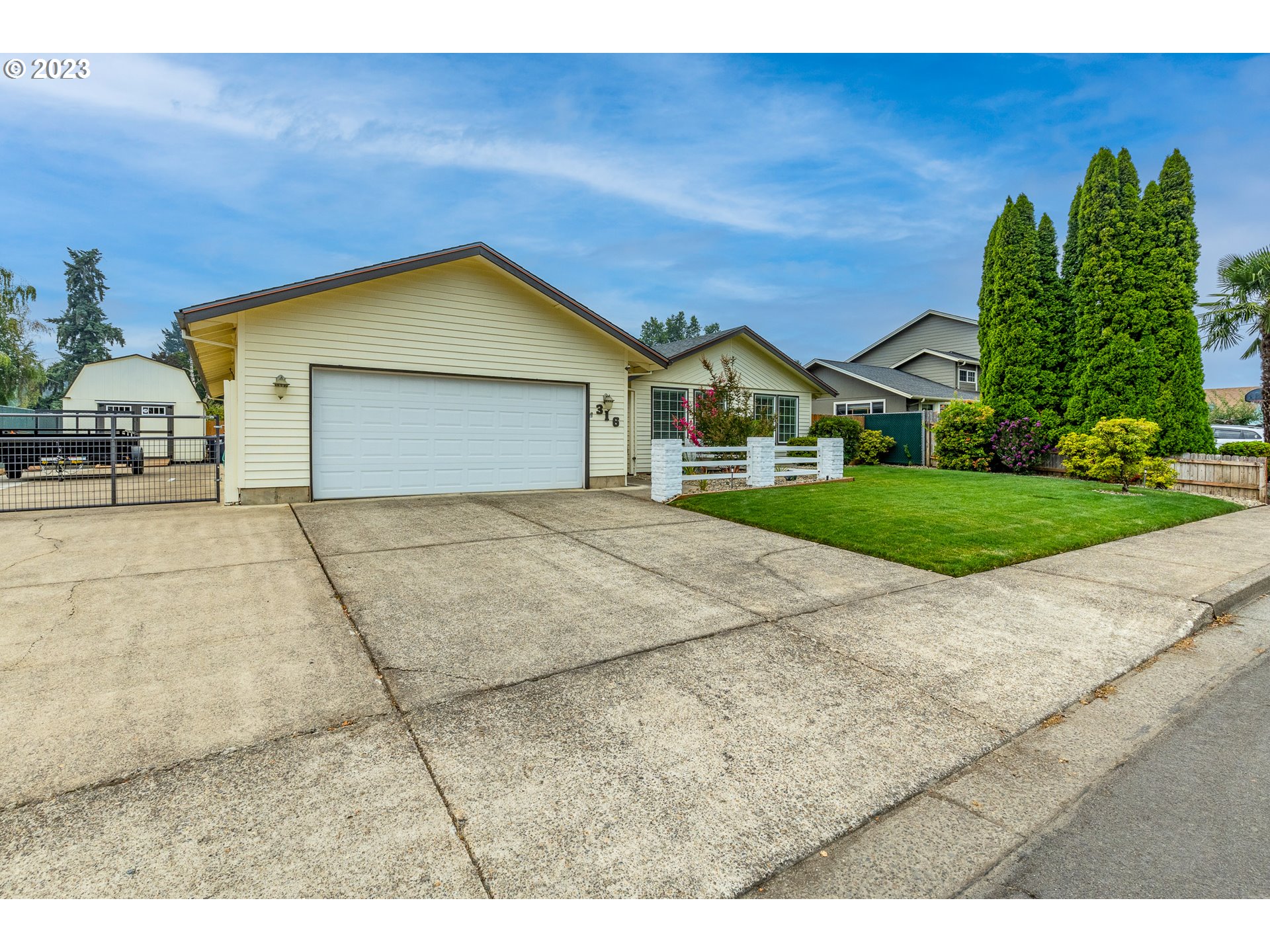 316 70th Street Springfield, OR 97478 - Photo 2 of 25 a front view of a house with a garden and garage