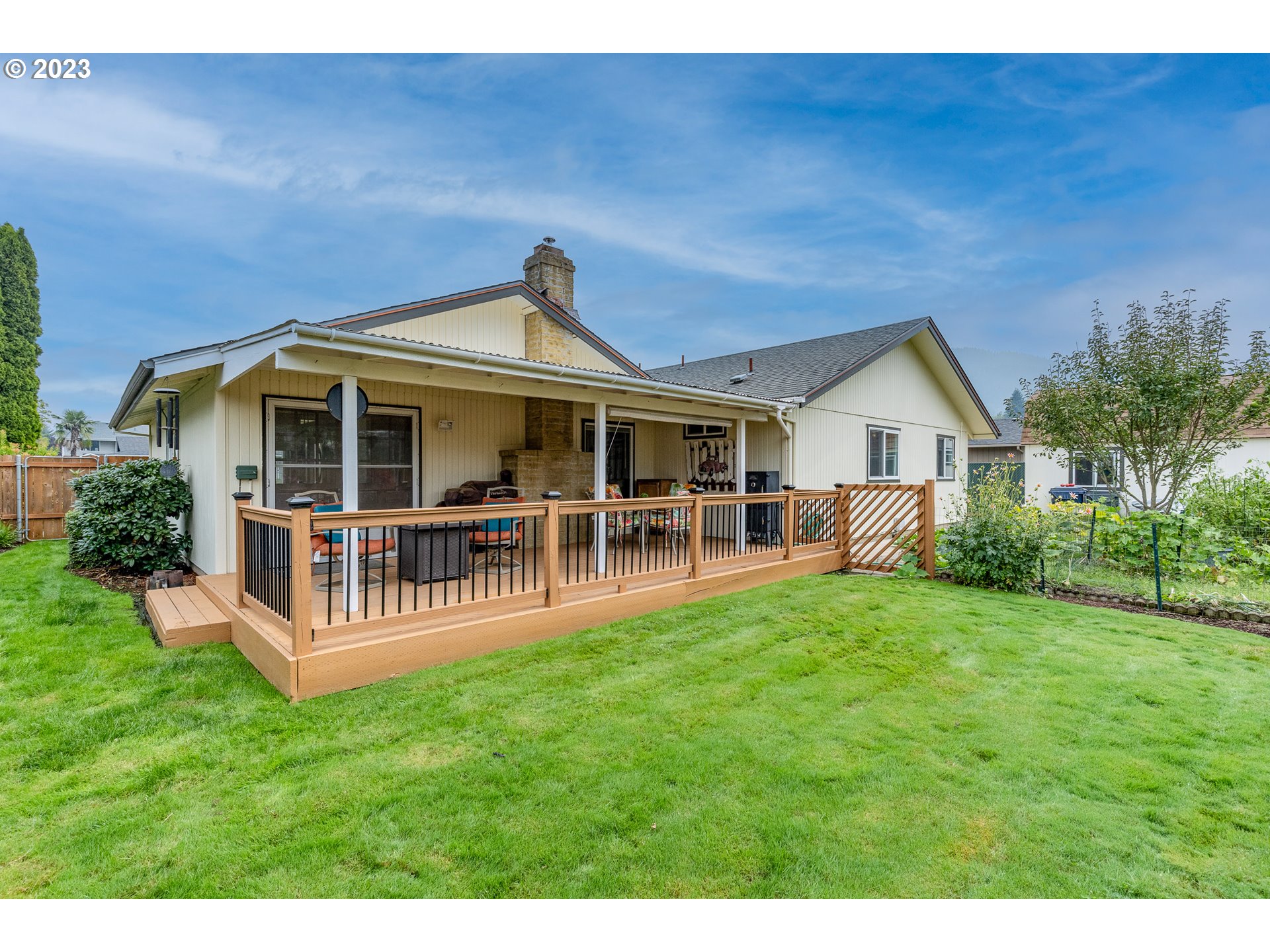 316 70th Street Springfield, OR 97478 - Photo 21 of 25 a front view of a house with a yard table and chairs