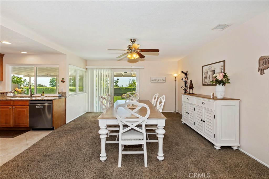 8527 Hillside Road Rancho Cucamonga, CA 91701 - Photo 12 of 50 a dining room with furniture a window and a kitchen