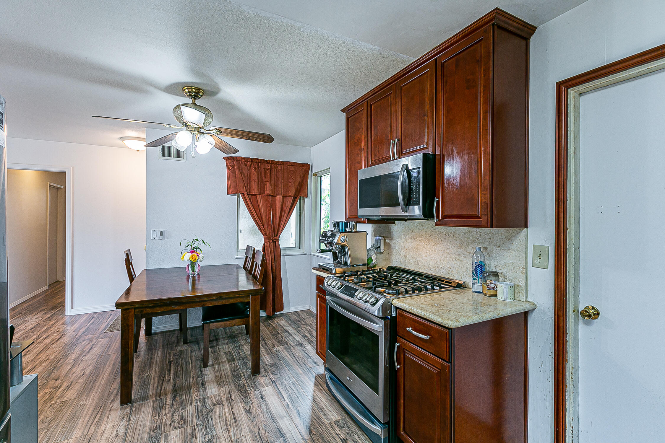 321 South T Street Lompoc, CA 93436 - Photo 14 of 29 a kitchen that has a table chairs and a stove