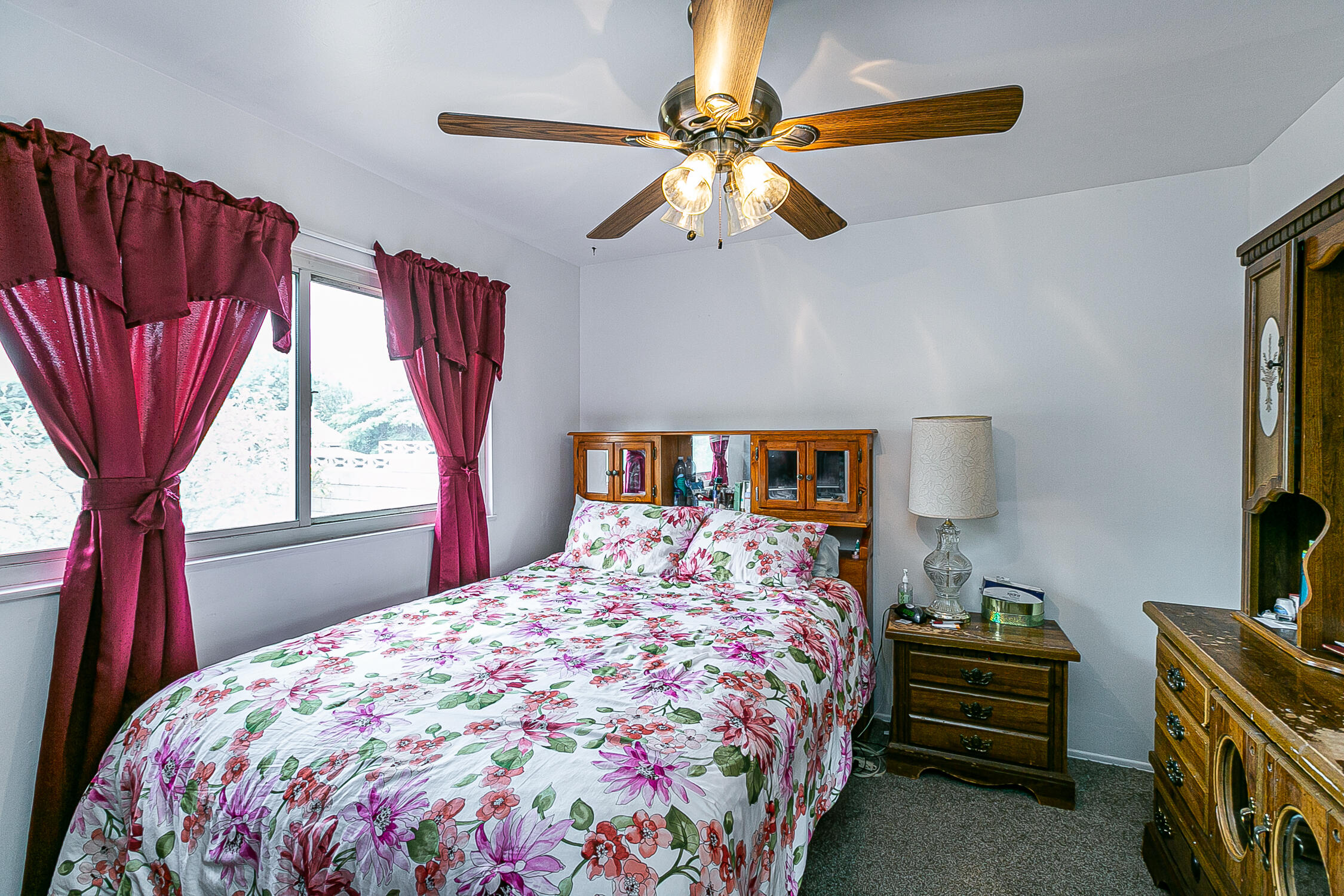 321 South T Street Lompoc, CA 93436 - Photo 20 of 29 a bedroom with a bed and a chandelier
