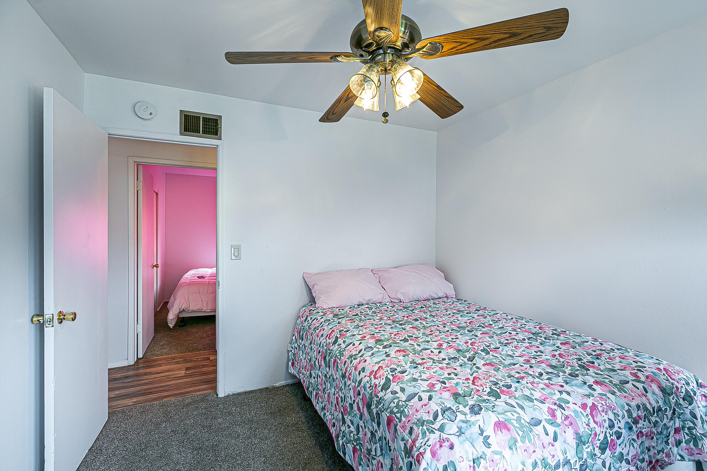321 South T Street Lompoc, CA 93436 - Photo 22 of 29 a bedroom with a bed and a chandelier