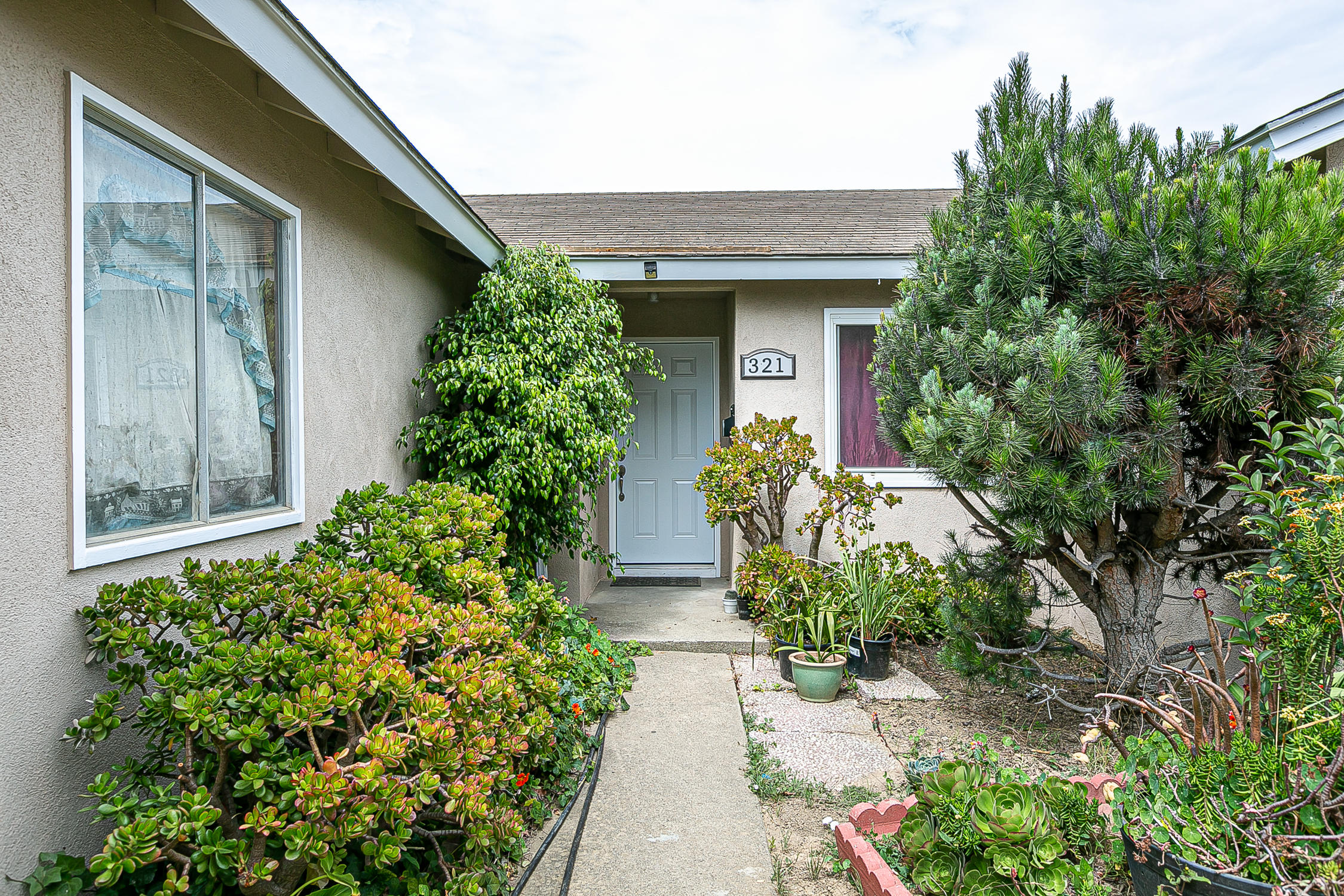 321 South T Street Lompoc, CA 93436 - Photo 4 of 29 front view of a house with potted plants