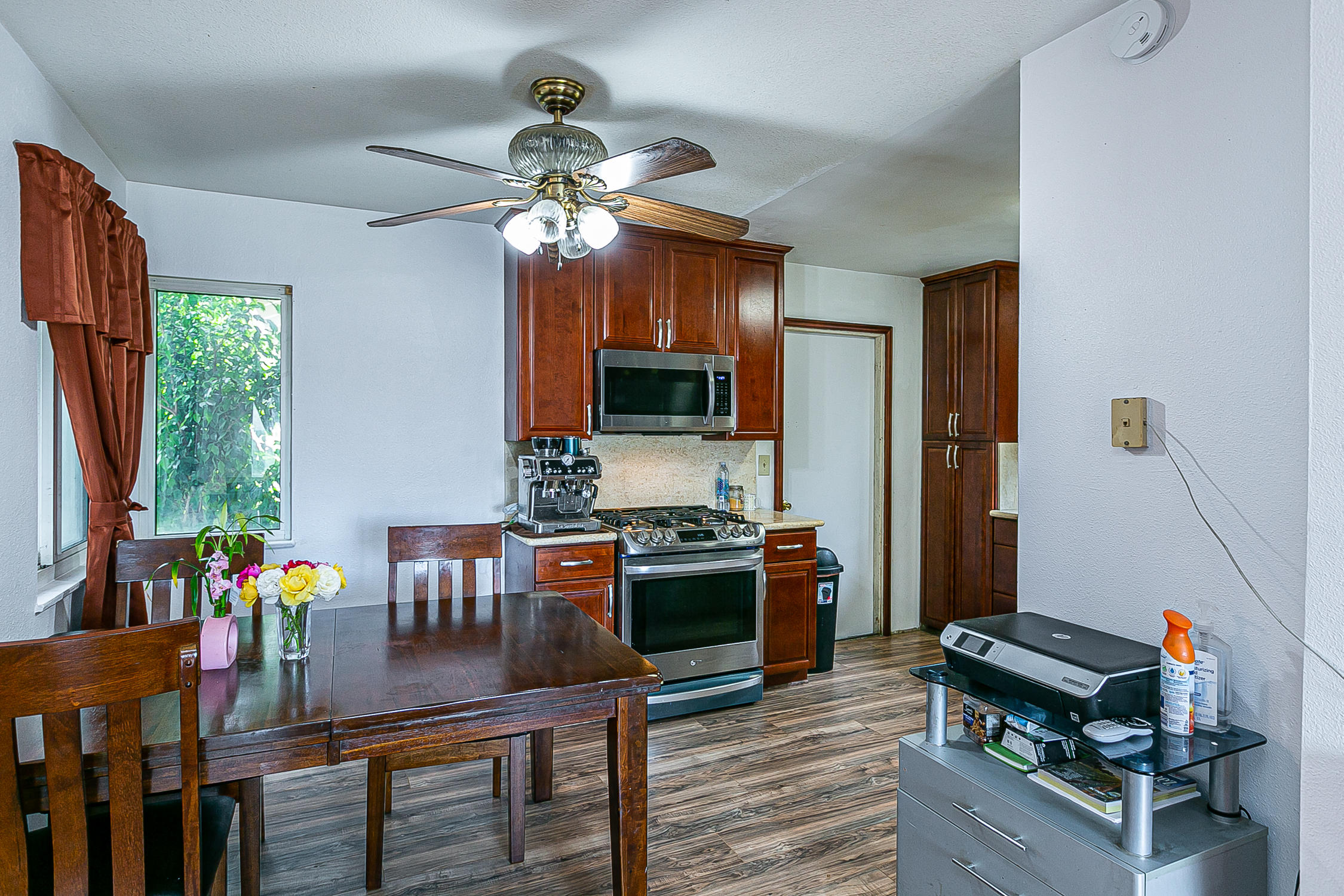 321 South T Street Lompoc, CA 93436 - Photo 10 of 29 a view of a dining room with furniture a chandelier and wooden floor