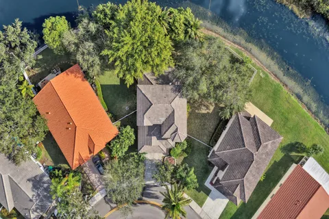 an aerial view of a house with a yard and garden