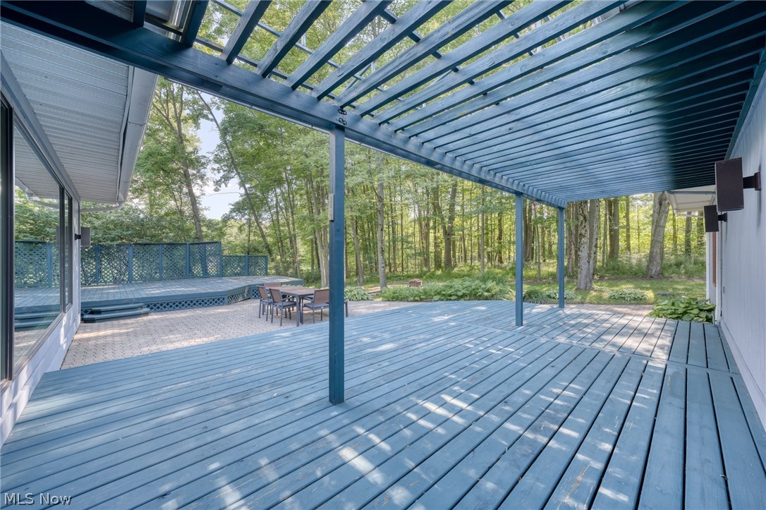 4830 Som Center Road Moreland Hills, OH 44022 - Photo 41 of 48 A pergola-topped deck invites you to linger: dappled sunlight filters through the wooden slats above, casting playful shadows over lazy afternoons and golden evenings alike—the perfect perch for slowing down.