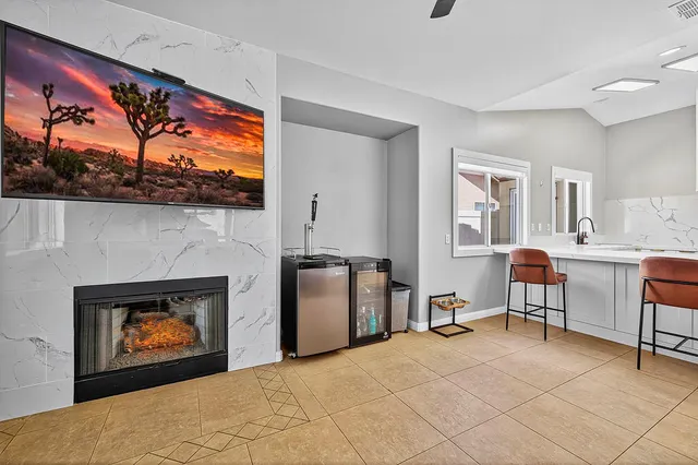 a living room with furniture a fireplace and wall painting