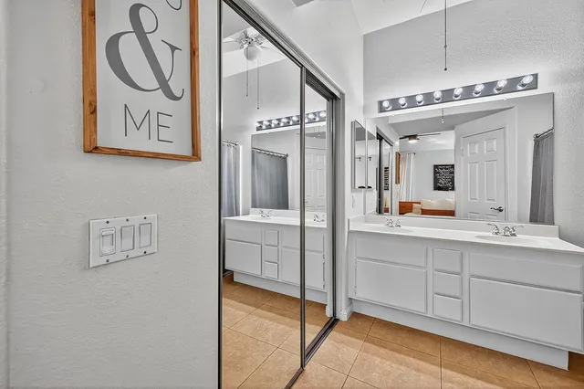 a spacious bathroom with a mirror a sink and a mirror
