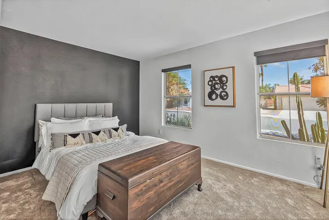 a bedroom with a bed and a window