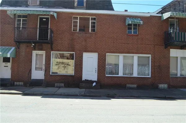 a front view of building with yard