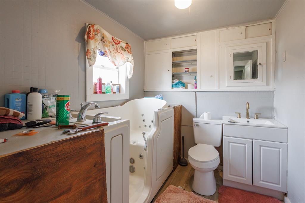 2202 Chester Street Sweetwater, TX 79556 - Photo 12 of 21 a bathroom with a toilet sink and mirror