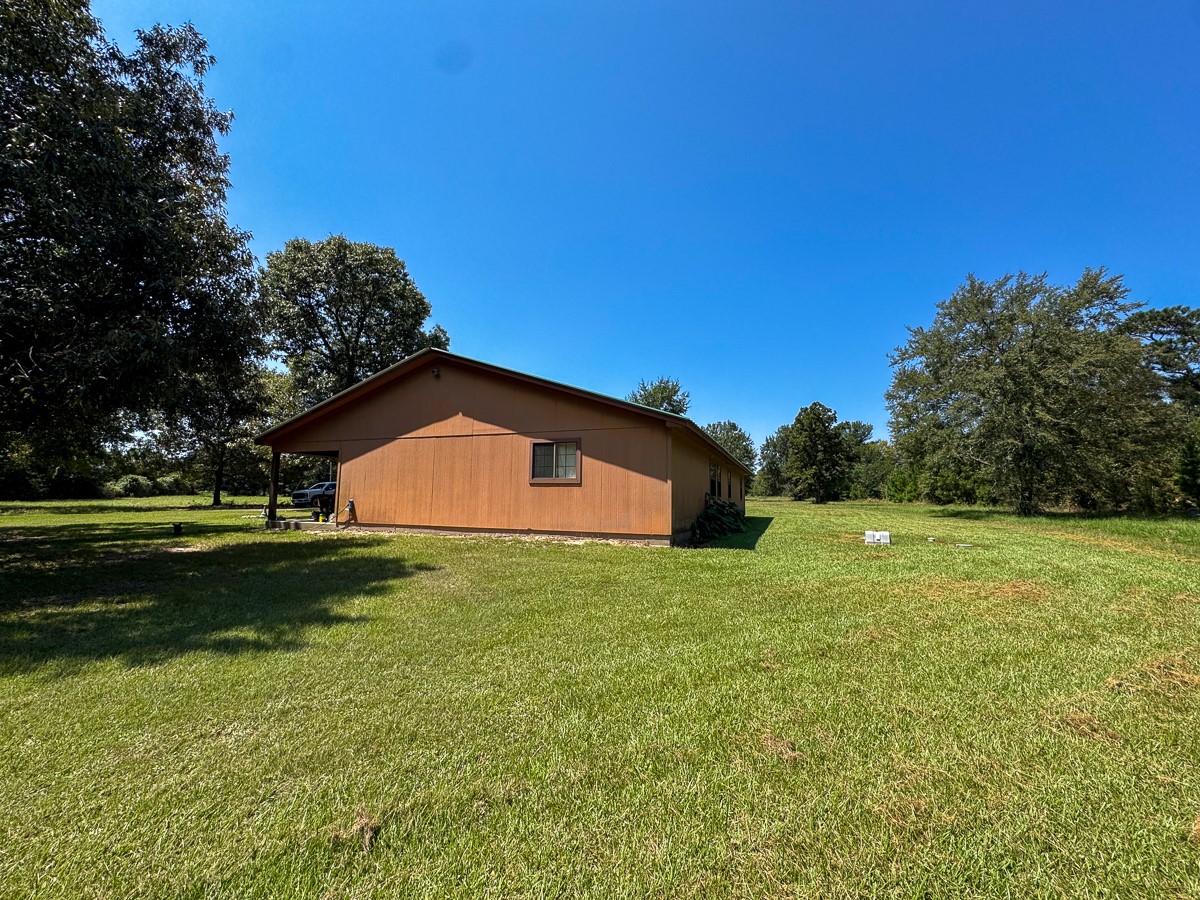 37 Archie Road Huntsville, TX 77320 - Photo 19 of 40 a backyard of a house with lots of green space