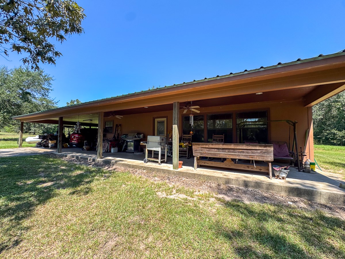 37 Archie Road Huntsville, TX 77320 - Photo 22 of 40 a view of a house with a large window and lawn chairs