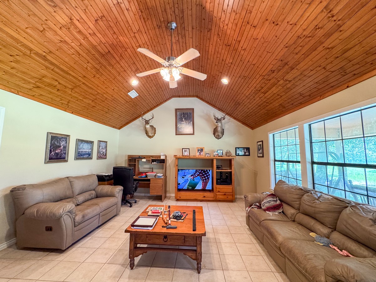 37 Archie Road Huntsville, TX 77320 - Photo 4 of 40 a living room with furniture a flat screen tv and a table
