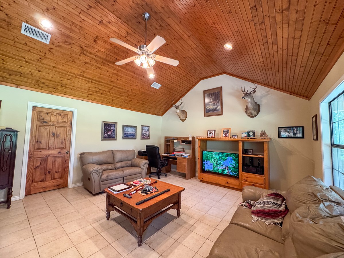 37 Archie Road Huntsville, TX 77320 - Photo 5 of 40 a living room with furniture a flat screen tv and a fireplace