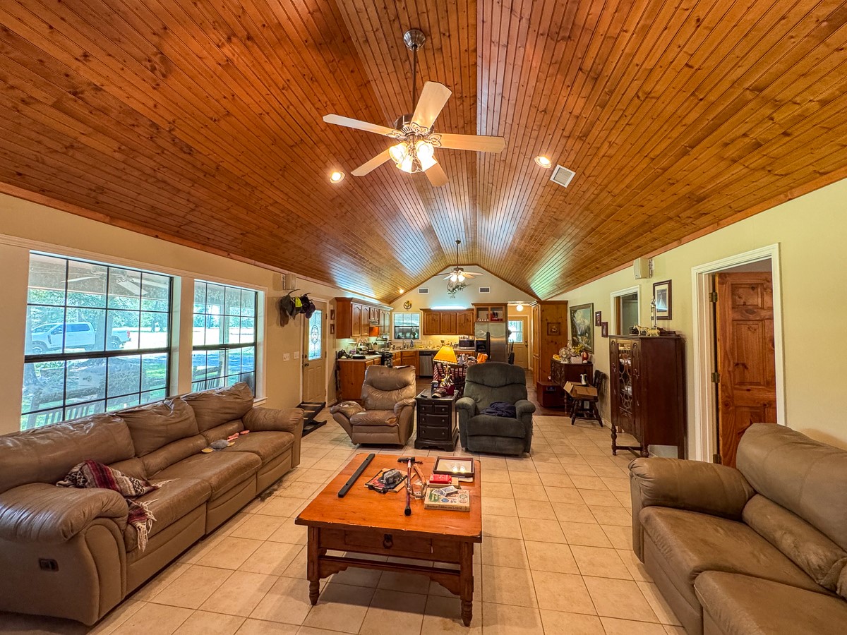 37 Archie Road Huntsville, TX 77320 - Photo 6 of 40 a living room with furniture a flat screen tv and a chandelier