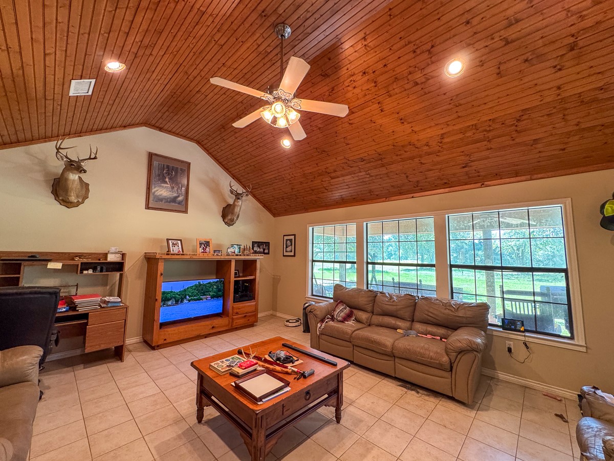 37 Archie Road Huntsville, TX 77320 - Photo 7 of 40 a living room with furniture a flat screen tv and a fireplace