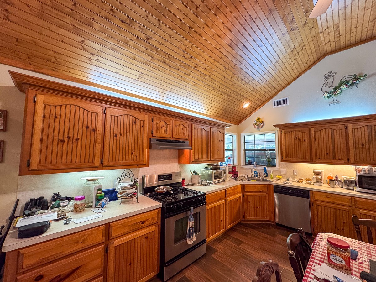 37 Archie Road Huntsville, TX 77320 - Photo 8 of 40 a kitchen with a sink a stove cabinets and a window