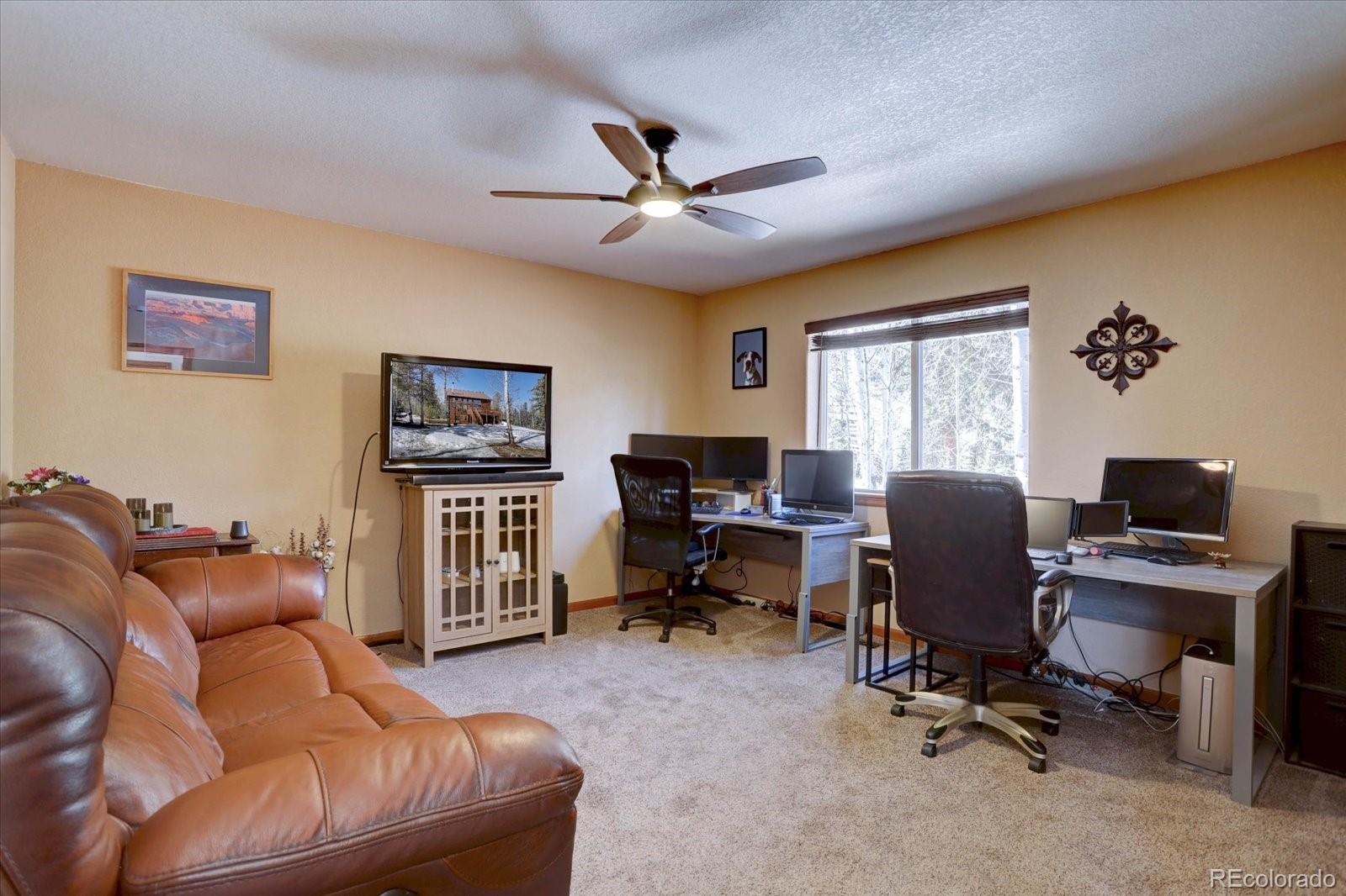 10438 Sunlight Lane Conifer, CO 80433 - Photo 17 of 48 a view of a livingroom with workspace and a window
