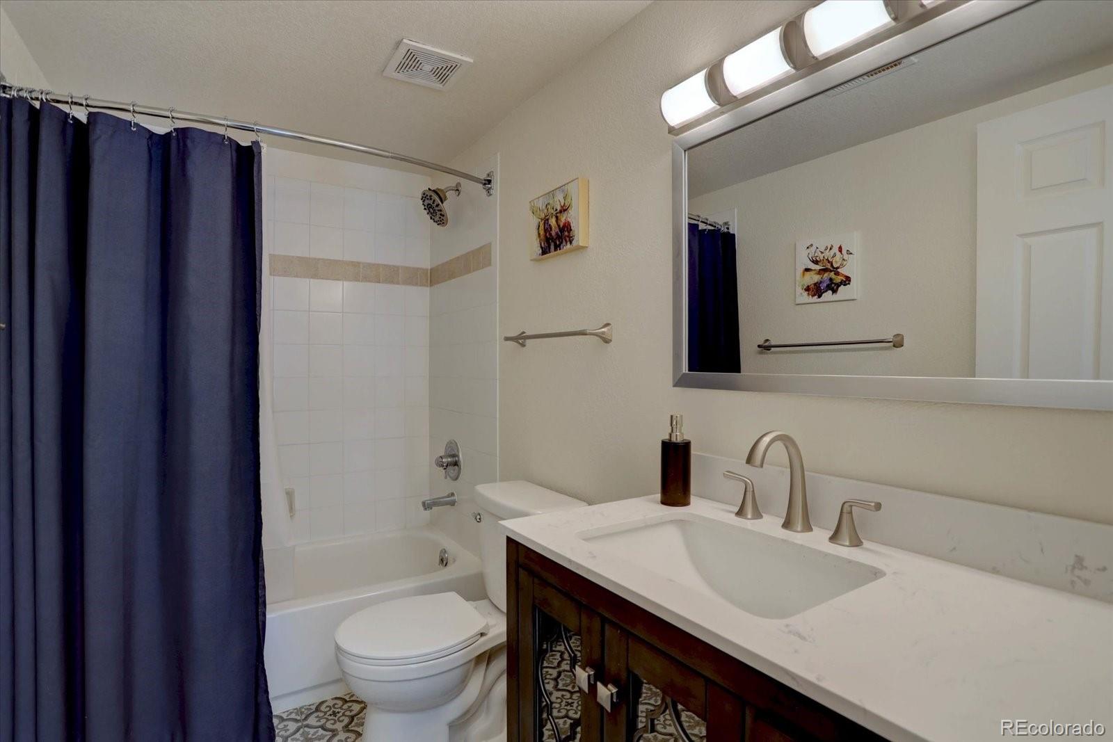 10438 Sunlight Lane Conifer, CO 80433 - Photo 31 of 48 a bathroom with a granite countertop sink toilet and shower