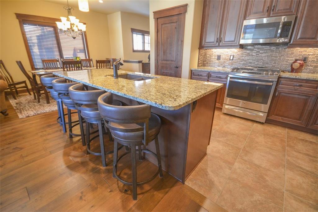 835 Independence Road, Unit 6B Keystone, CO 80435 - Photo 15 of 30 a dining hall with stainless steel appliances a dining table and chairs